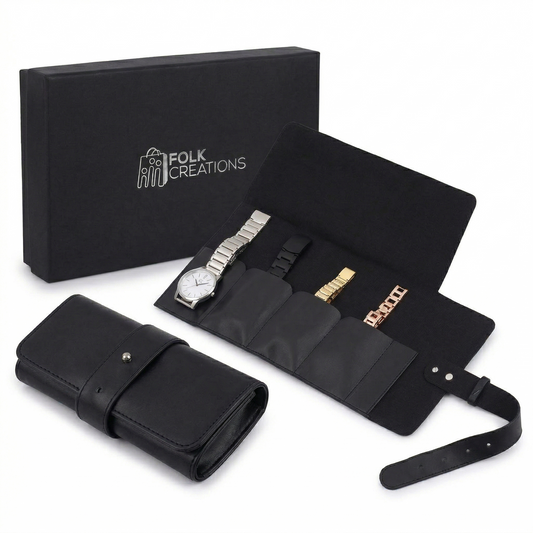 Black travel watch roll unrolled with four watches in padded pockets, beside the rolled case and its Folk Creations gift box