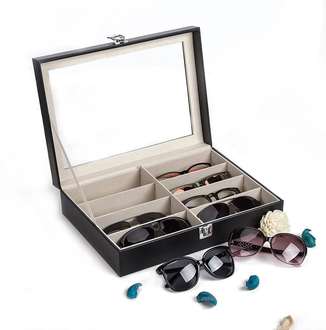 Black eight-slot sunglasses organiser box open with folded sunglasses in velvet-lined slots under a transparent lid